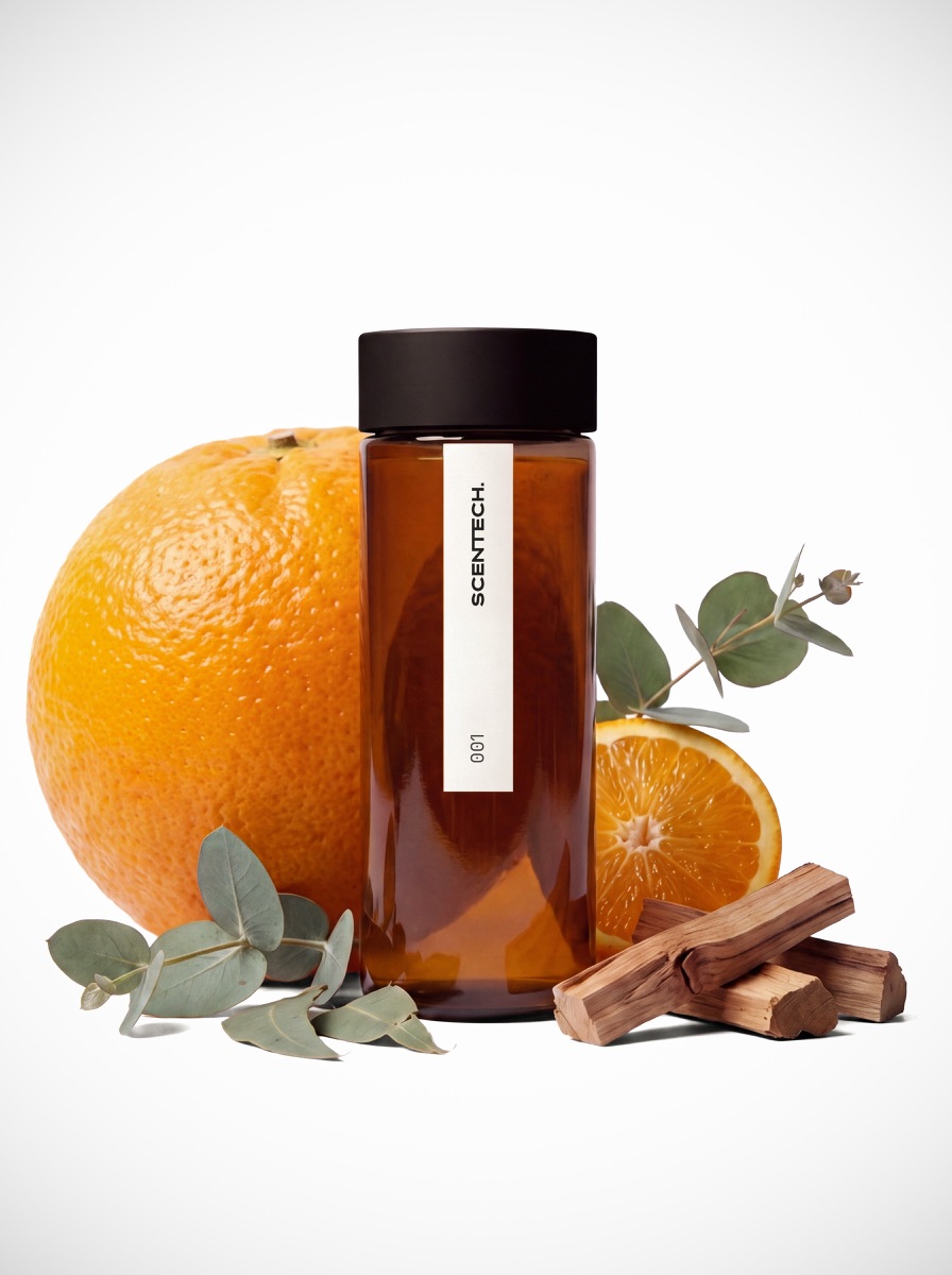 A 65 ml amber ScentPod bottle of Scentech Clean Energy fragrance oil standing beside its box